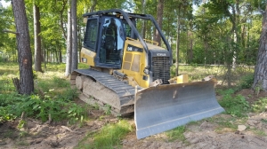 Bulldozer with land grading equipment