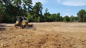 Small dozer grading soil