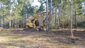 Excavator cleaning up lot