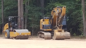 Building pad compacter and excavator